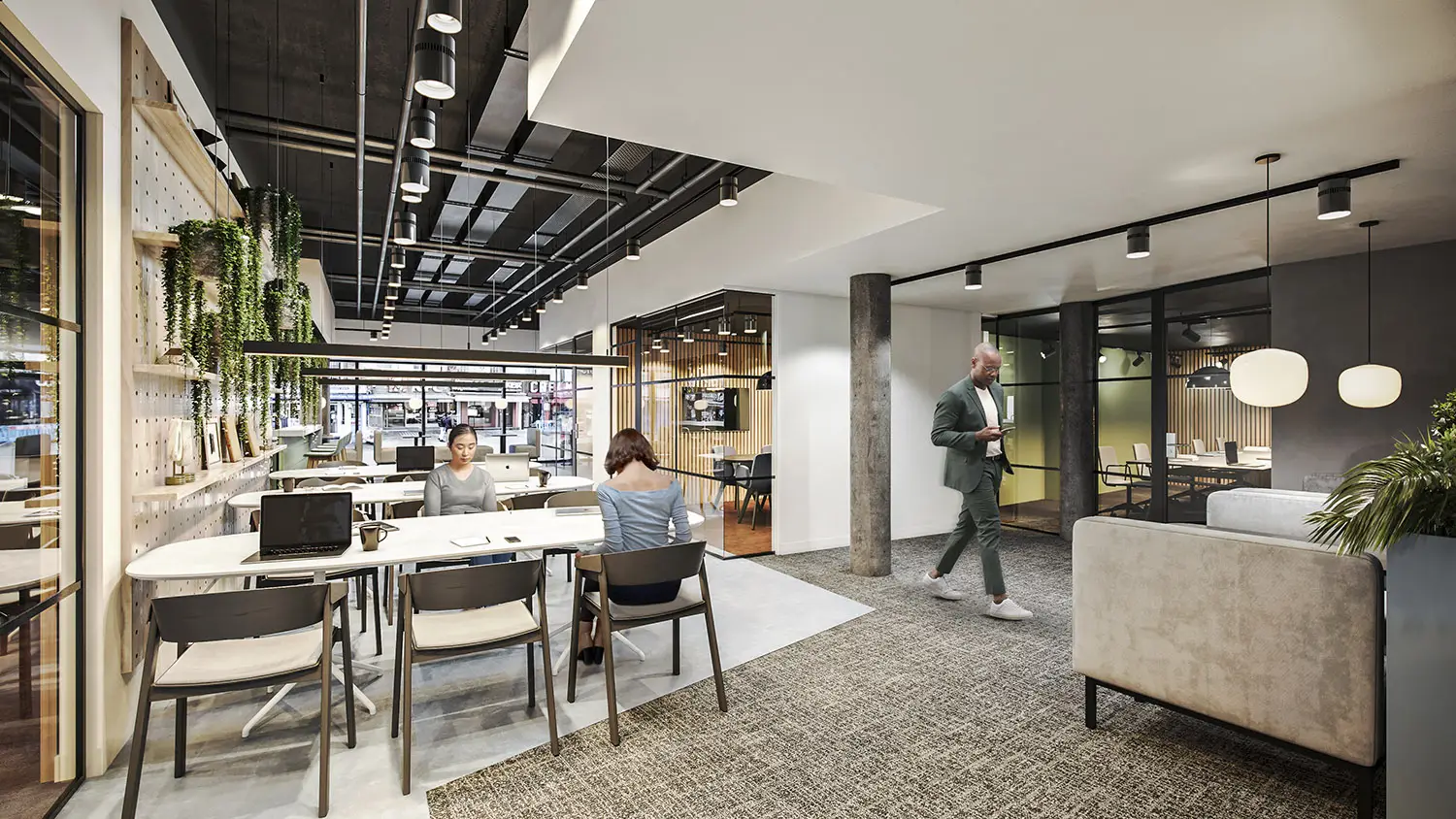 3D render of a contemporary office space with shared desks, plants, and a man walking, by 100CGI Studio.