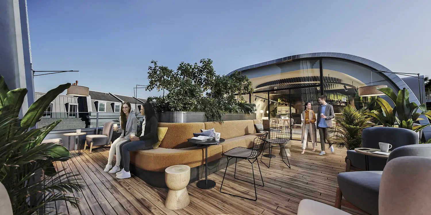 People enjoying a stylish rooftop terrace with modern seating, plants, and evening city views.