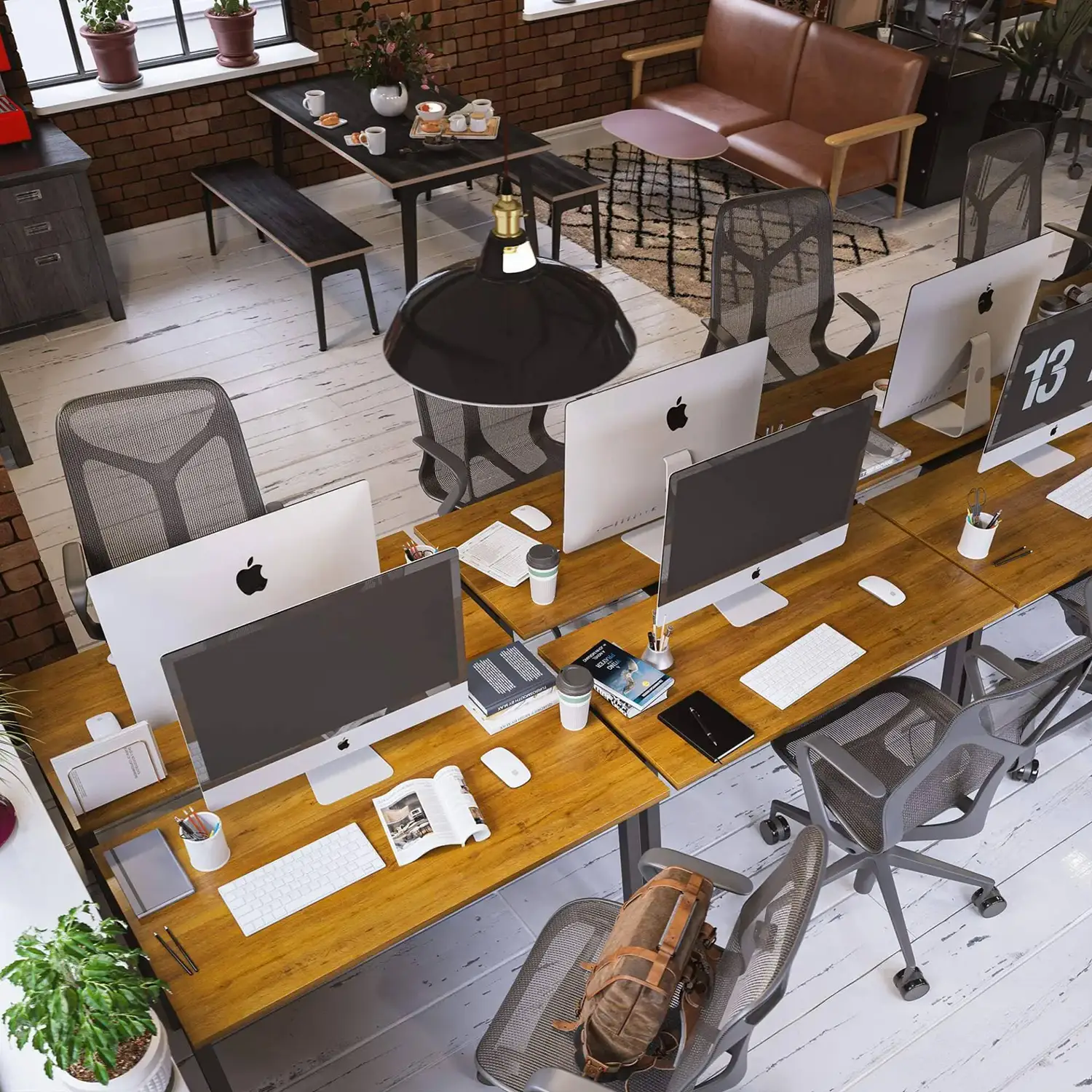 Stylish office workspace with wooden desks, modern chairs, and computers, seen from above.