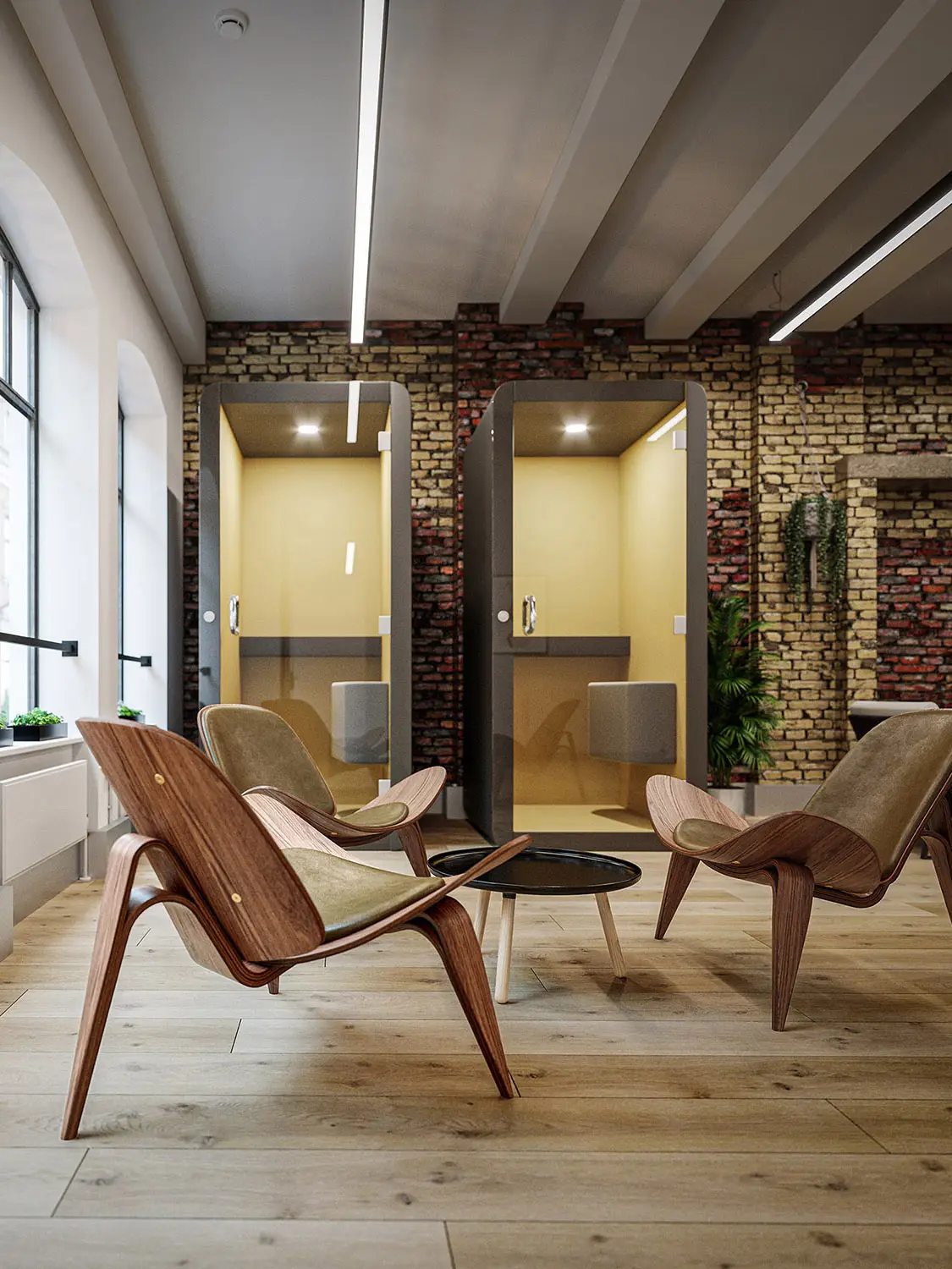 Render of a modern office with lounge chairs and private pods against an exposed brick wall.