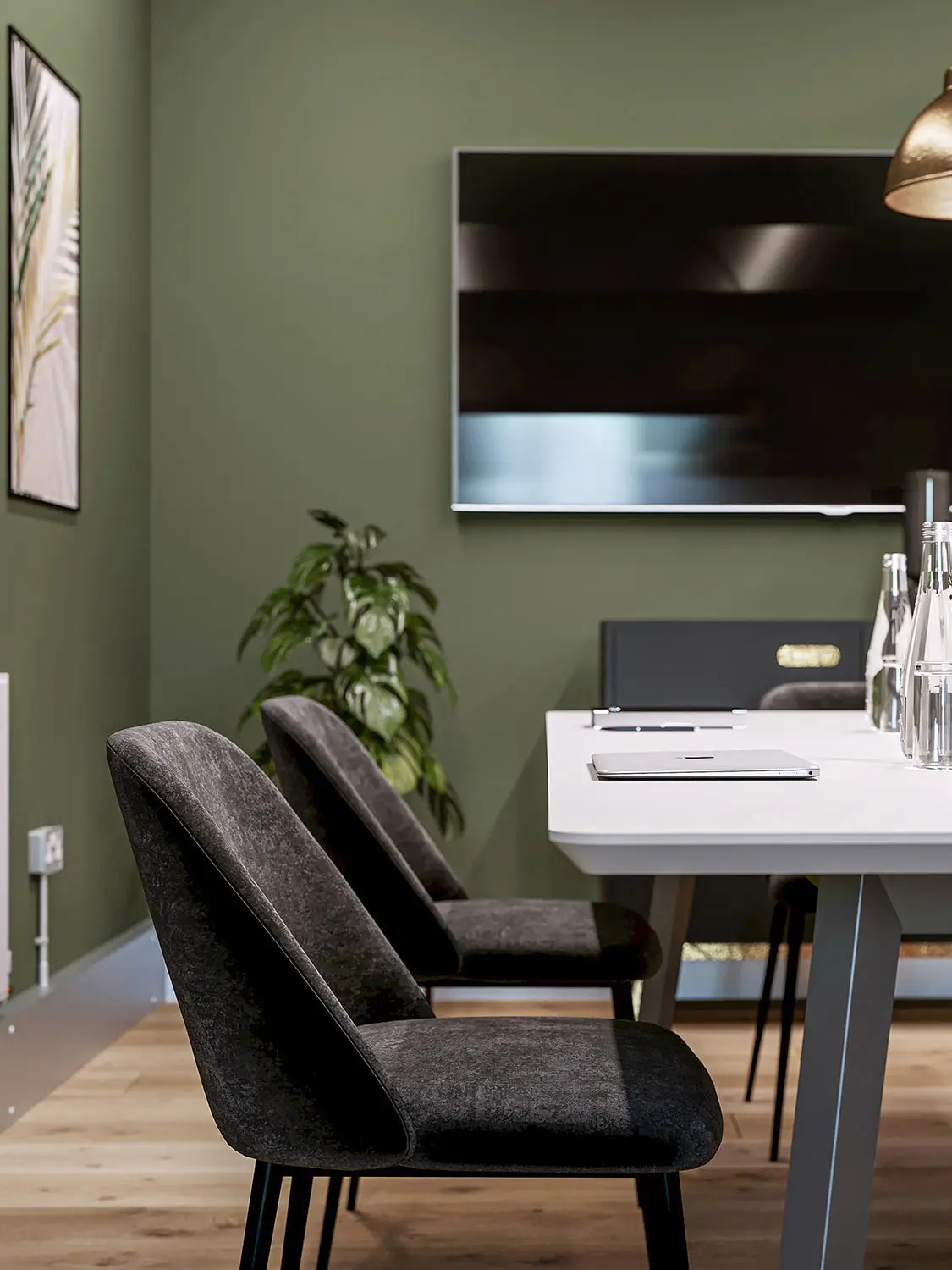 Modern office interior render with green walls, dark upholstered chairs, and a white table, by 100CGI Studio.